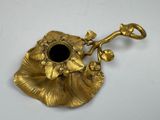 brass plate with a black stone in the center and a flower on it