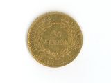 a gold coin on a white surface with a white background