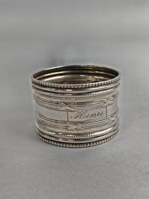 a close up of a silver ring on a table