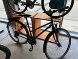 two bikes that are hanging on a rack in a store