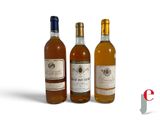 three bottles of wine sitting next to each other on a white surface