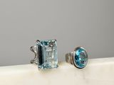 an image of a pair of blue topaze and white topaze rings