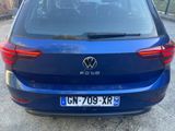 the back of a blue vw golf parked in a parking lot