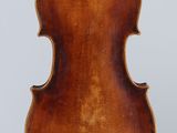an antique violin with a wooden back and a wooden bow