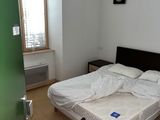 un lit dans une chambre avec une chaise et une fenêtre