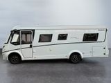 a small white rv parked on a parking lot