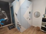 an image of a room with a locker and a wall mural