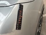 a measuring tape on the hood of a car