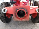a red lawn mower that is sitting on the ground