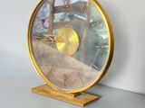 a clock that is sitting on a table in front of a wall