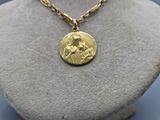the necklace has a gold coin with a picture of jesus on it