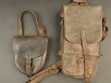 pair of old leather purses sitting on top of a gray surface
