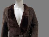 a mannequin wearing a brown coat with a fur collar