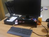 a desk with a keyboard, mouse, and monitor on it