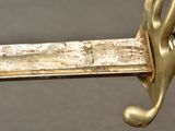 a close up of a sword with a hand on it