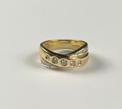 a close up of a gold ring with diamonds on a white surface