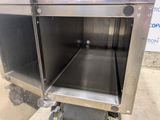 a stainless steel oven with a door open on a cart