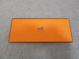 a close up of an orange box on a gray surface