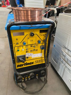 a close up of a machine with a copper pot on top of it