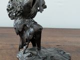 a statue of a woman and a dog on a table