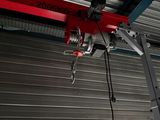 a crane that is hanging from the ceiling of a building