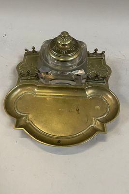 an antique brass plate with an ornate design on it