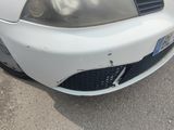 a picture of a white car with a denting front bumper