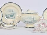 a lot of plates and cups that are sitting on a table