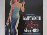 une vieille affiche de cinéma représentant une femme en robe bleue tenant une cigarette