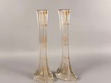 pair of clear glass vases sitting on top of a white surface