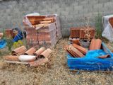 many different types of bricks in a pile on the ground
