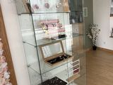 a glass display case in the corner of a room