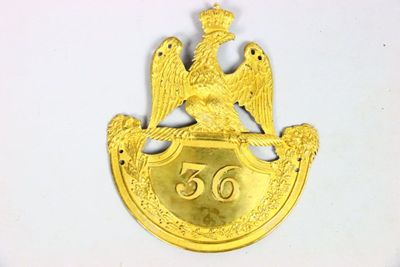 an image of a gold badge with a bird on it
