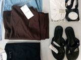 a lot of clothing and shoes laid out on a table
