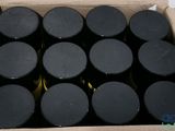 a cardboard box filled with black bottles of wine