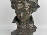 a close up of a statue of a man ' s head on a white background