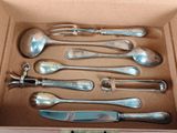 six spoons and a fork in a box