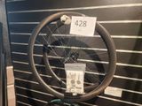 a bicycle wheel on display with a price tag on it