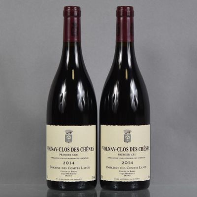two bottles of red wine sitting on top of a table