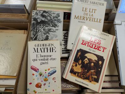 several books are stacked on top of each other on a table