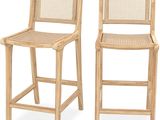 two wooden barstools with wicker backrests against a white background