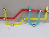 a multicolored coat rack on the wall
