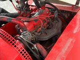 a close up of the engine of a red tractor