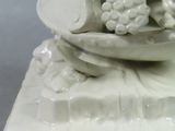 a figurine of a bowl of grapes on a plate