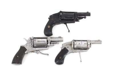 two revolvers are shown on a white surface with a white background