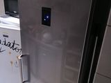 a refrigerator with a microwave on top of it in a kitchen