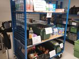a blue cart that has many items on it