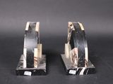 pair of black and white marble bookends on black background
