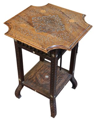 an image of a wooden table with intricate carvings on it