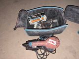 a suitcase with a hair dryer and other items in it